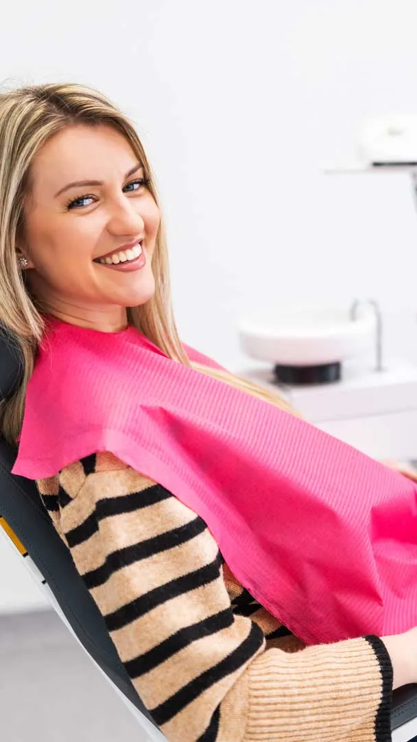 A patient smiling during a visit to Park Avenue Dental's Murray Hill treatment room